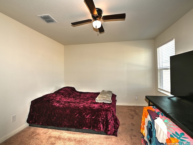 11719 Claudette St, San Antonio, TX 78252 - carpeted bedroom featuring baseboards and a ceiling fan