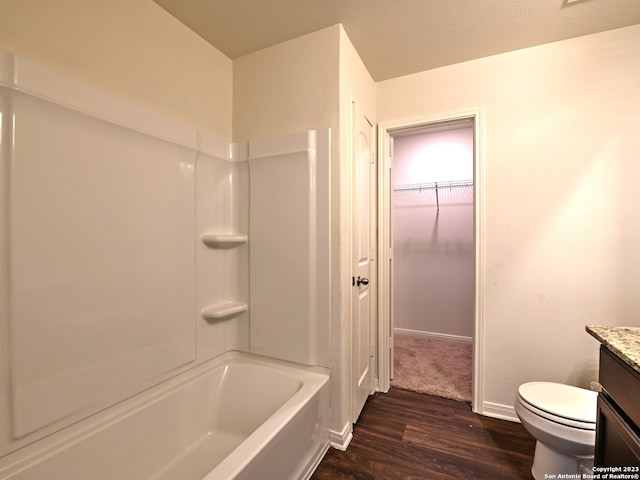 11719 Claudette St, San Antonio, TX 78252 - full bathroom with vanity, wood finished floors, toilet, baseboards, and  shower combination