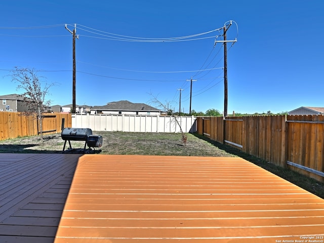 11719 Claudette St, San Antonio, TX 78252 - wooden deck with area for grilling and a fenced backyard