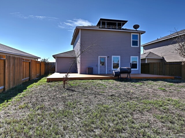11719 Claudette St, San Antonio, TX 78252 - back of house featuring a fenced backyard, a deck, and central AC