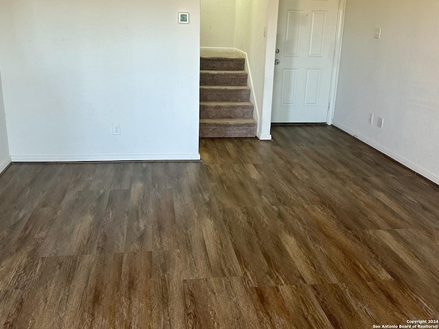 11719 Claudette St, San Antonio, TX 78252 - spare room featuring baseboards, dark wood finished floors, and stairway