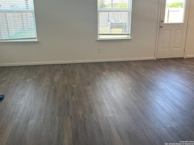 11719 Claudette St, San Antonio, TX 78252 - unfurnished room with plenty of natural light, baseboards, and dark wood finished floors
