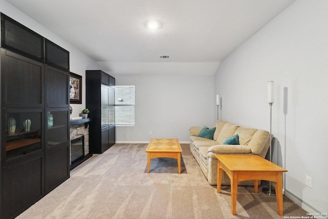 8911 Rancher Pl, Seguin, TX 78155 - living area featuring light carpet, baseboards, and a stone fireplace