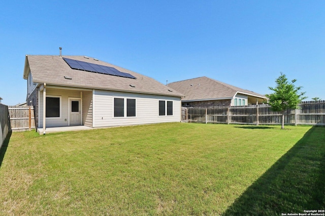 8911 Rancher Pl, Seguin, TX 78155 - rear view of house with solar panels, a patio, and roof with shingles