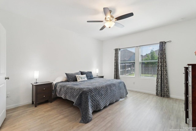 8911 Rancher Pl, Seguin, TX 78155 - bedroom with light wood-style flooring, baseboards, and ceiling fan