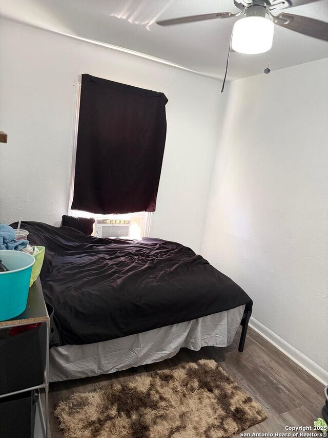 2902 Christian Dr, San Antonio, TX 78222 - bedroom with wood finished floors, cooling unit, a ceiling fan, and baseboards