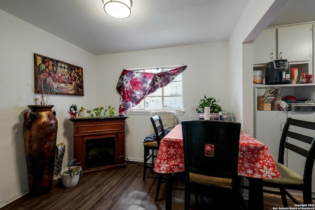 2902 Christian Dr, San Antonio, TX 78222 - dining room featuring wood finished floors and a fireplace