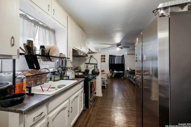 2902 Christian Dr, San Antonio, TX 78222 - kitchen featuring appliances with stainless steel finishes, under cabinet range hood, a sink, ceiling fan, and white cabinetry