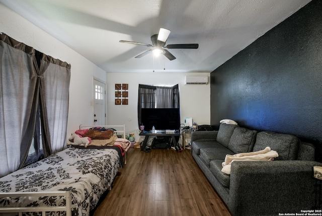 2902 Christian Dr, San Antonio, TX 78222 - bedroom with a wall unit AC, wood finished floors, and a ceiling fan