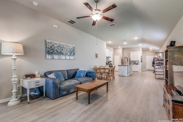 13627 Crossbow, San Antonio, TX 78253 - living room featuring vaulted ceiling, a ceiling fan, light wood-style flooring, and baseboards