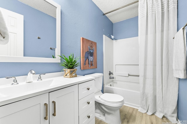 9206 Dancove Dr, San Antonio, TX 78250 - bathroom featuring a textured ceiling, wood finished floors, toilet, vanity, and shower / bath combination with curtain