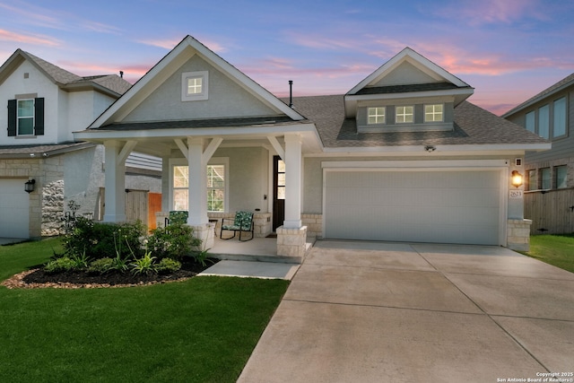 view of front of property with stone siding, covered porch, an attached garage, and a front yard