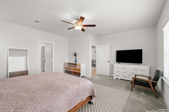carpeted bedroom with a ceiling fan and baseboards