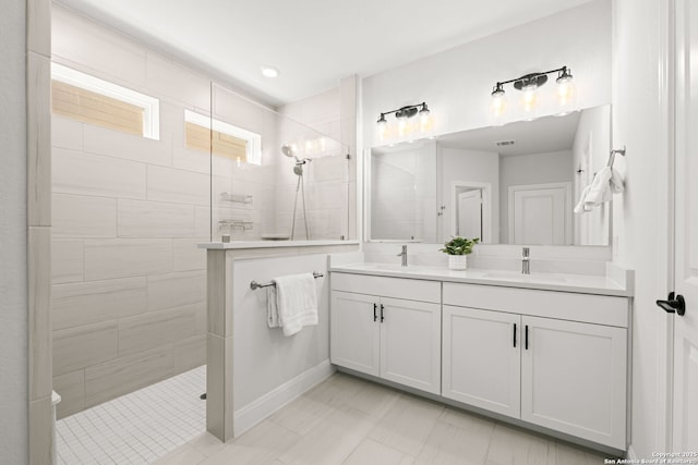 bathroom with walk in shower and double vanity
