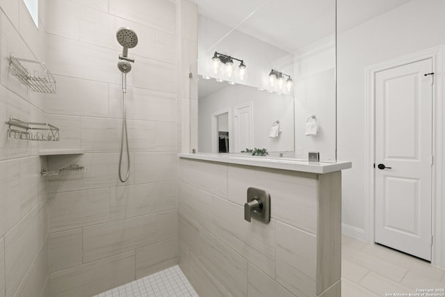 full bath with tiled shower and tile patterned floors