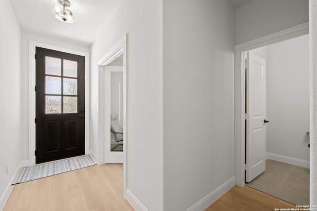 foyer featuring wood finished floors and baseboards