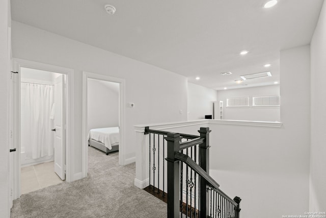 hallway with an upstairs landing, carpet flooring, recessed lighting, and baseboards