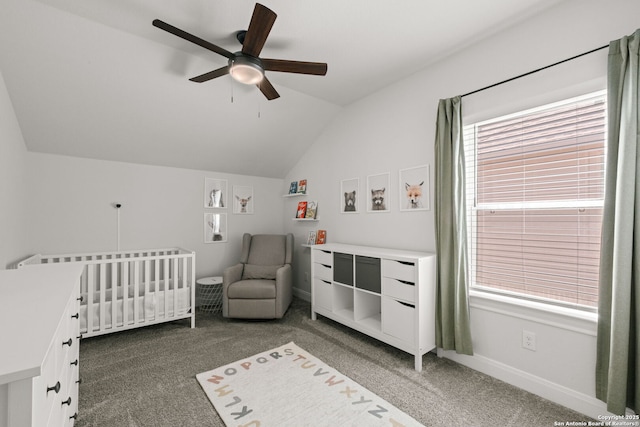 bedroom with carpet flooring, lofted ceiling, a nursery area, baseboards, and ceiling fan