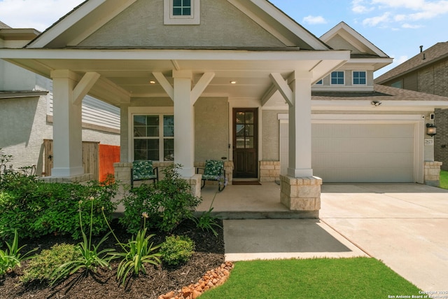 view of front of house featuring a porch, driveway, and stucco siding