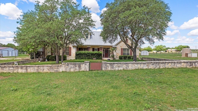24935 Pecan Crk, San Antonio, TX 78255 - view of front of house featuring a shed, an outdoor structure, and a front yard