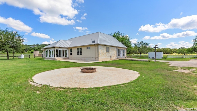 24935 Pecan Crk, San Antonio, TX 78255 - back of house featuring an outdoor fire pit, a patio area, and metal roof