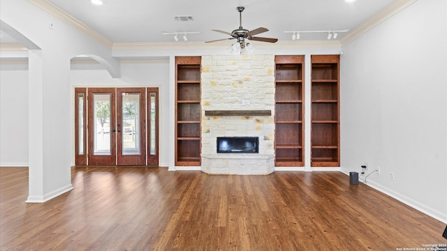 24935 Pecan Crk, San Antonio, TX 78255 - unfurnished living room featuring a ceiling fan, arched walkways, wood finished floors, crown molding, and a fireplace