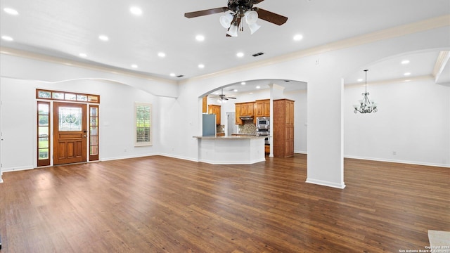 24935 Pecan Crk, San Antonio, TX 78255 - unfurnished living room featuring a ceiling fan, ornamental molding, dark wood-type flooring, recessed lighting, and arched walkways