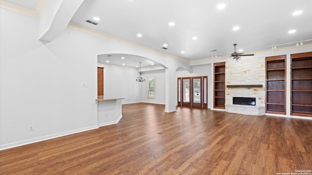24935 Pecan Crk, San Antonio, TX 78255 - unfurnished living room featuring crown molding, wood finished floors, a stone fireplace, built in features, and ceiling fan