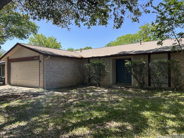 4659 Misty Run, San Antonio, TX 78217 - ranch-style house with brick siding, an attached garage, a front lawn, and concrete driveway