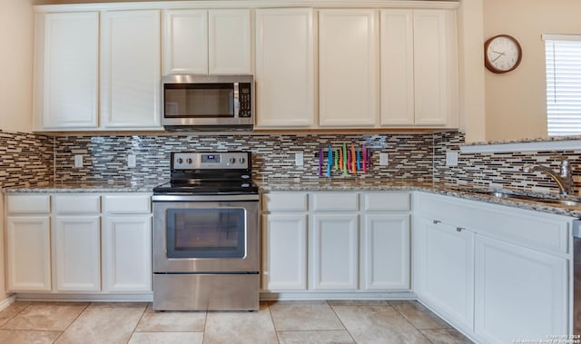 414 Harvest Pt, Selma, TX 78154 - kitchen with stainless steel appliances, tasteful backsplash, white cabinets, and light stone countertops