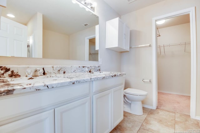 414 Harvest Pt, Selma, TX 78154 - full bath featuring toilet, double vanity, a walk in closet, tile patterned floors, and baseboards