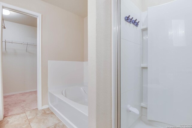 414 Harvest Pt, Selma, TX 78154 - full bathroom with a spacious closet, a bath, a shower, and tile patterned flooring
