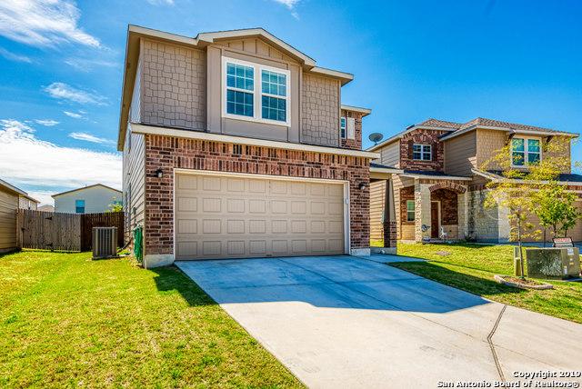 414 Harvest Pt, Selma, TX 78154 - view of front facade featuring central air condition unit, an attached garage, driveway, and brick siding