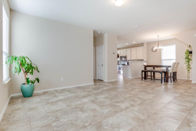 414 Harvest Pt, Selma, TX 78154 - living room with a chandelier, light tile patterned floors, and baseboards