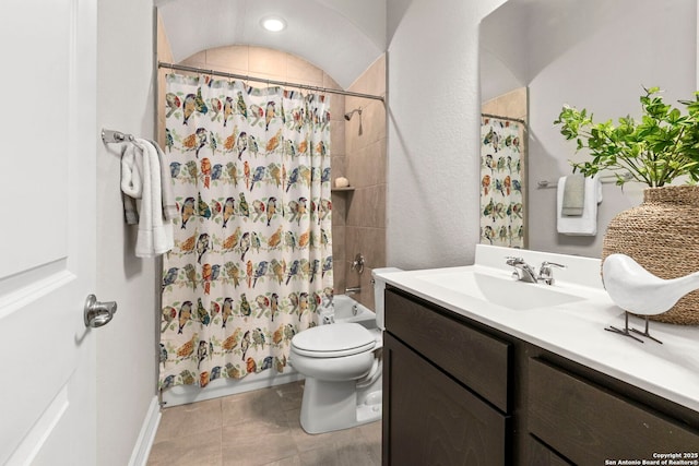 bathroom featuring shower / bath combo with shower curtain, vanity, toilet, and tile patterned floors