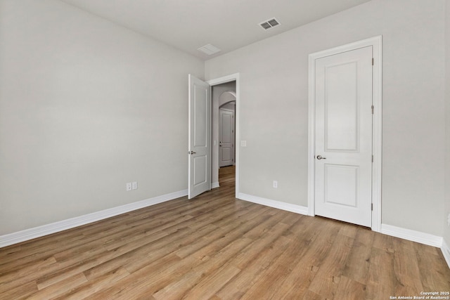 unfurnished bedroom featuring light wood finished floors and baseboards