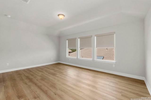 spare room with light wood finished floors and baseboards