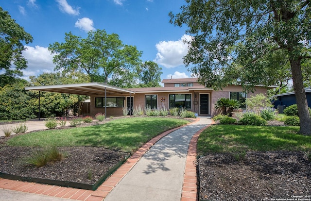 635 Brightwood Pl, San Antonio, TX 78209 - view of front of house featuring a front lawn, brick siding, and a carport
