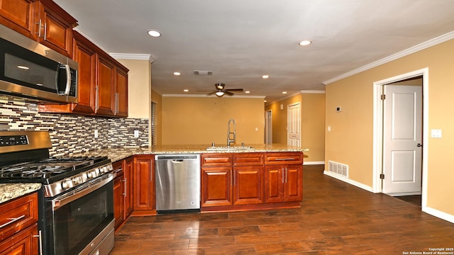 8526 Glen Breeze, San Antonio, TX 78239 - kitchen with appliances with stainless steel finishes, a peninsula, a sink, a ceiling fan, and dark wood finished floors