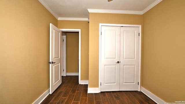 8526 Glen Breeze, San Antonio, TX 78239 - unfurnished bedroom with crown molding, dark wood finished floors, baseboards, and a closet