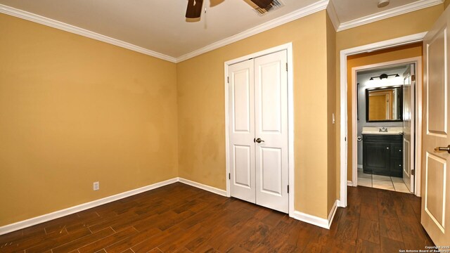 8526 Glen Breeze, San Antonio, TX 78239 - unfurnished bedroom featuring dark wood finished floors, ornamental molding, baseboards, a sink, and a closet