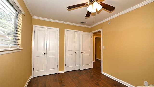 8526 Glen Breeze, San Antonio, TX 78239 - unfurnished bedroom featuring two closets, dark wood-style floors, baseboards, and ornamental molding