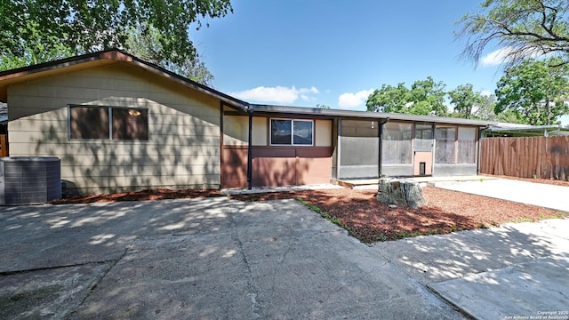 8526 Glen Breeze, San Antonio, TX 78239 - view of front of house featuring central air condition unit, a sunroom, a patio area, and fence