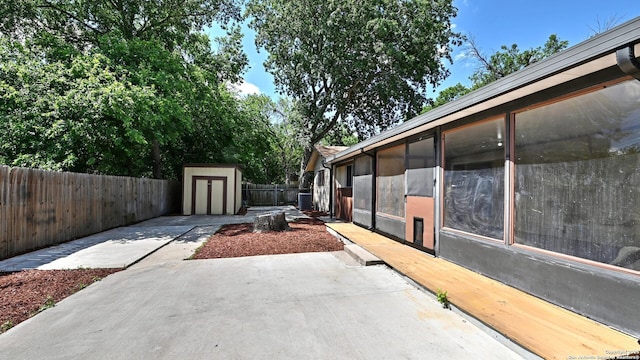8526 Glen Breeze, San Antonio, TX 78239 - view of property exterior with a patio area, a storage unit, an outbuilding, a fenced backyard, and cooling unit