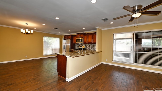 8526 Glen Breeze, San Antonio, TX 78239 - kitchen with stainless steel appliances, crown molding, a peninsula, baseboards, and a chandelier