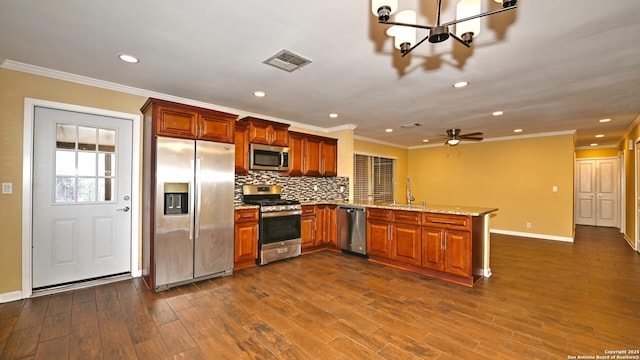 8526 Glen Breeze, San Antonio, TX 78239 - kitchen featuring appliances with stainless steel finishes, a peninsula, baseboards, recessed lighting, and ornamental molding
