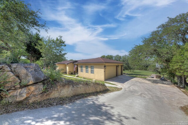 211 Comal Run, Bulverde, TX 78163 - view of property exterior featuring driveway and a garage