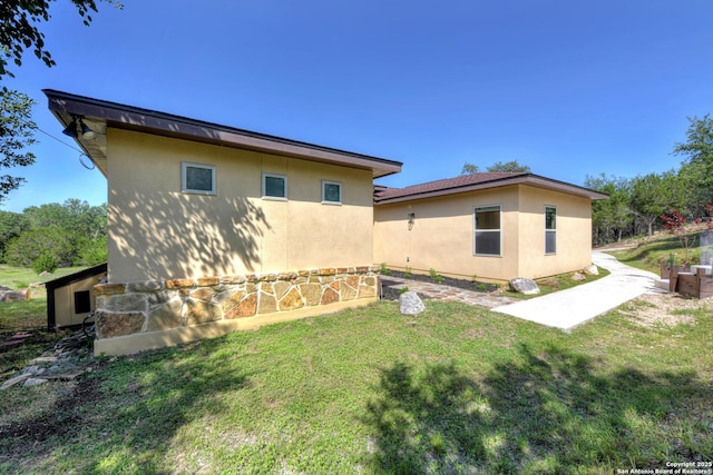 211 Comal Run, Bulverde, TX 78163 - view of home's exterior featuring stucco siding and a yard
