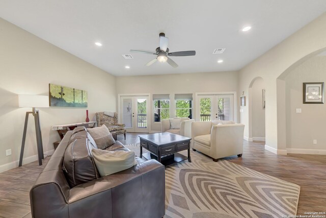 211 Comal Run, Bulverde, TX 78163 - living room featuring arched walkways, wood finished floors, a ceiling fan, baseboards, and recessed lighting