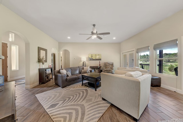 211 Comal Run, Bulverde, TX 78163 - living room featuring arched walkways, ceiling fan, baseboards, light wood finished floors, and recessed lighting